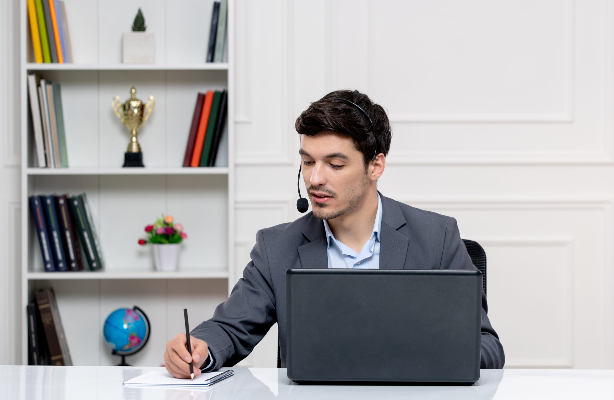 customer-service-handsome-man-grey-suit-with-computer-headset-taking-down-notes
