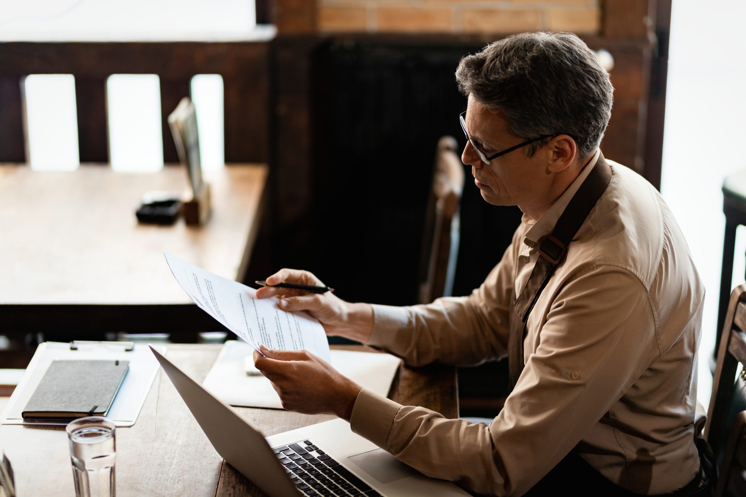 Coffee shop owner going through paperwork after working hours