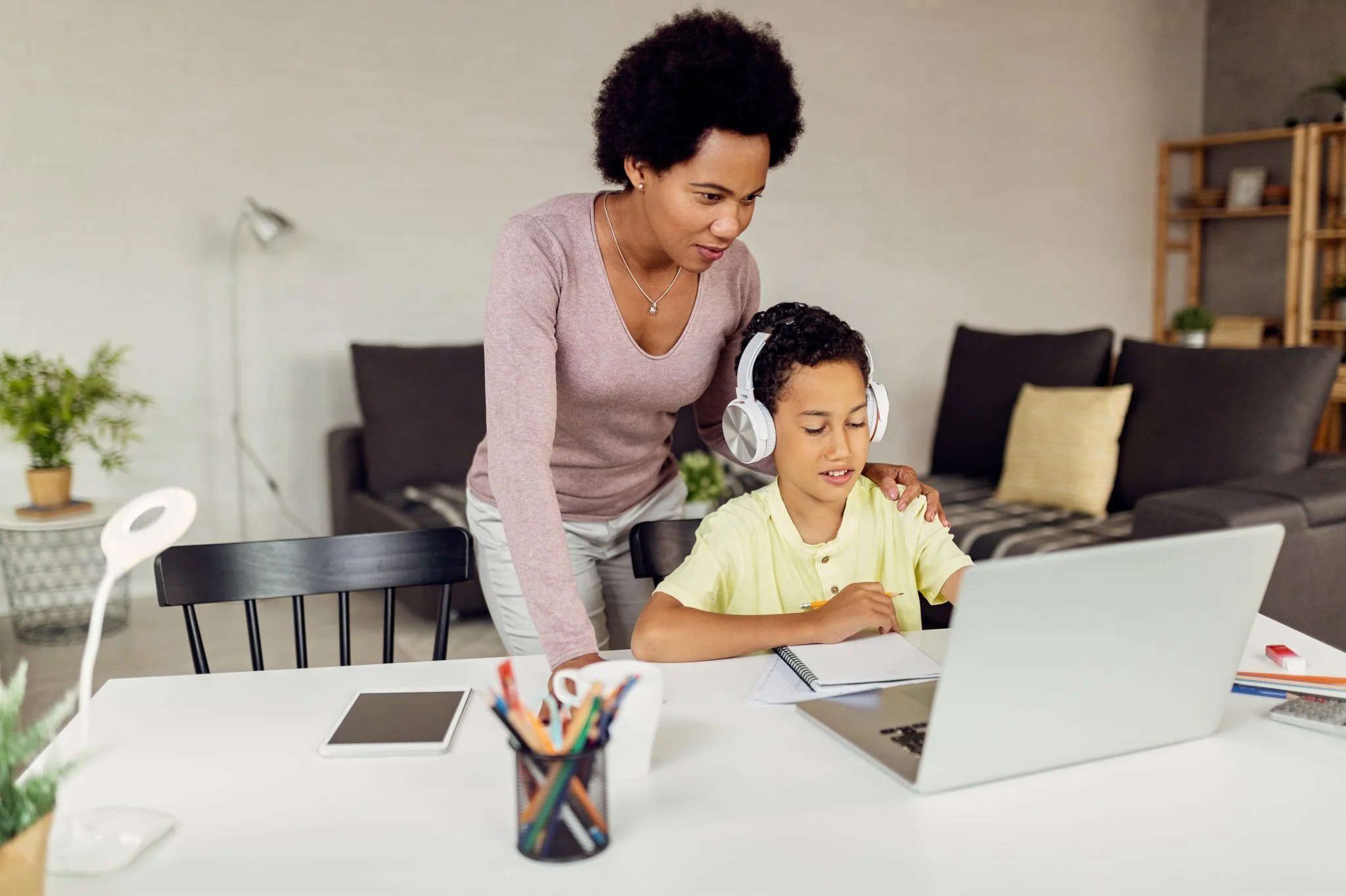african-american-mother-assisting-her-son-elearning-home-2048x1365